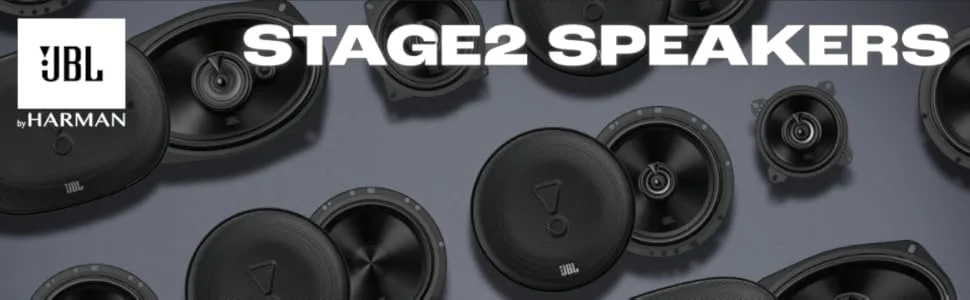 Text reads 'JBL STAGE2 SPEAKERS'. Close-up view of car audio speakers with black cones arranged in a display.
